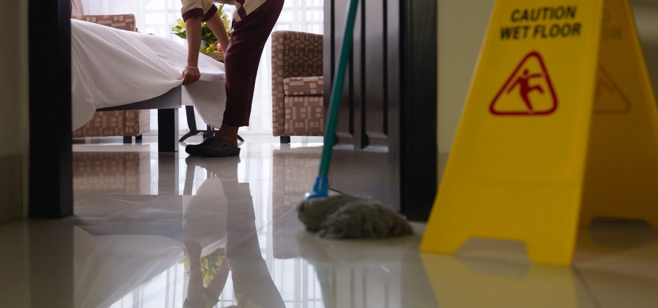 Maid At Work And Cleaning In Luxury Hotel Room